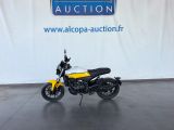 yellow and black motorcycle parked in front of an auction sign