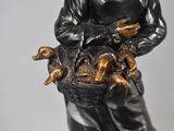 a statue of a man holding a basket of animals