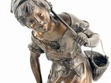 bronze statue of a woman with a basket of flowers