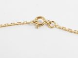 a close up of a gold chain bracelet on a white background