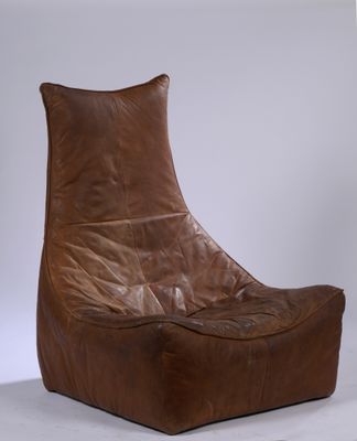 brown leather lounge chair on white surface with white background