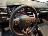 dashboard of a car with a steering wheel and a dash light