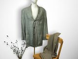 un mannequin assis à côté d'une chaise sur laquelle est posé un costume
