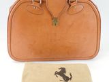 an image of a brown leather bag with a horse logo on it