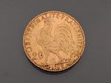 an image of a gold coin with a rooster on it ' s side