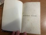 a person holding a book open on a table