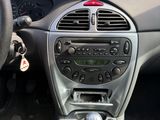 the interior of a car with a steering control and dashboard controls