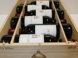 bottles of red wine in a wooden box on a table