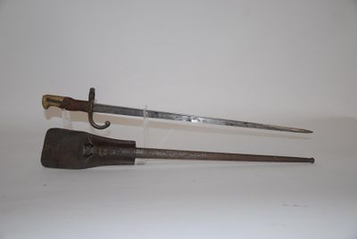 an old pair of swords on a white surface with a white background