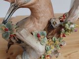 a figurine of a bird sitting on a table