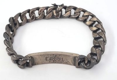 a close up of a bracelet with an engraved bar on it