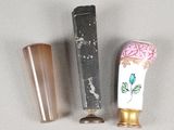 three different types of toothbrushes on a white surface