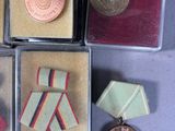 several medals and medals are in a display case on a table