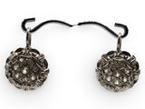 pair of antique silver earrings with diamonds on a white background