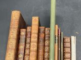 several old books are stacked on top of each other on a table