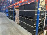 many black boxes stacked up in a large warehouse