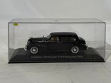 a black model of a car in a glass case