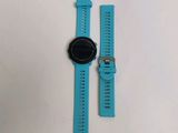 the watch is sitting on the table next to the watch strap