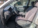 the interior of a car with the door open and the driver ' s seat down