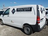 a white van parked in a parking lot with other cars