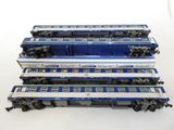 four blue and white train cars stacked on top of each other