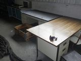 a desk with a drawer and a chair in a room