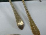 two spoons and a spoon rest on a table