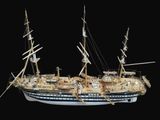 a model of a ship on display on a black background