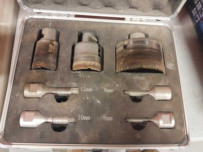 a metal case with tools inside of it on a table