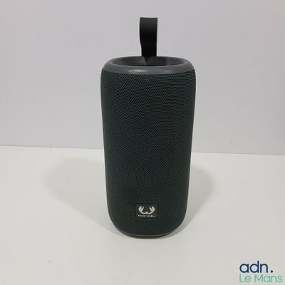 an image of a black speaker sitting on top of a white table