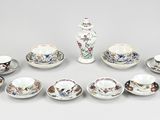 a lot of different types of tea cups and saucers on the table