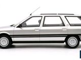 a silver car that is parked on a white surface