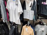 a lot of clothes hanging on a rack in a store