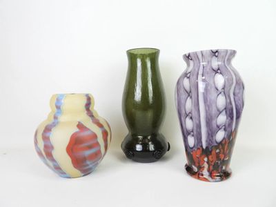 three vases sitting next to each other on a white surface