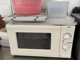 a microwave oven sitting on top of a counter with a bowl on top of it