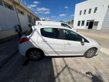 a small white car parked on the side of the road