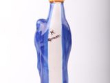 a blue and white vase with a gold crown on it