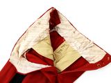 a red blanket with a white and black design on it