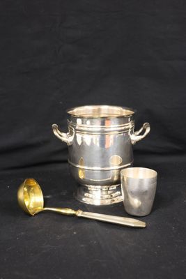 a silver ice bucket and spoon on a black background
