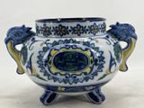 a blue and white vase with two birds on it