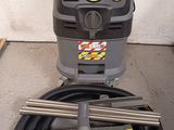 an image of a dust extracter with a hose attached to it