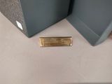 a gold bar on the floor next to a speaker