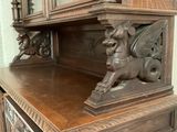 a wooden cabinet with a mirror on top of it
