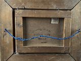 an old picture of a wooden frame with a blue rope around it