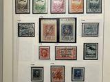 framed picture of a collection of stamps on display in a glass case