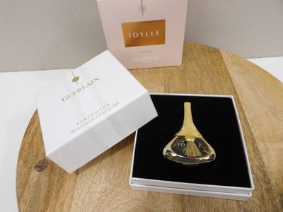 a bottle of perfume sitting on a table next to a box