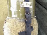 an image of a military helmet with a strap on it