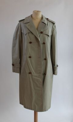 un manteau posé sur un pied de mannequin, sur fond blanc