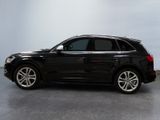 the black audi suv is parked in a room with a gray floor