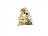 une image représentant une broche plaquée or ornée d'un palmier